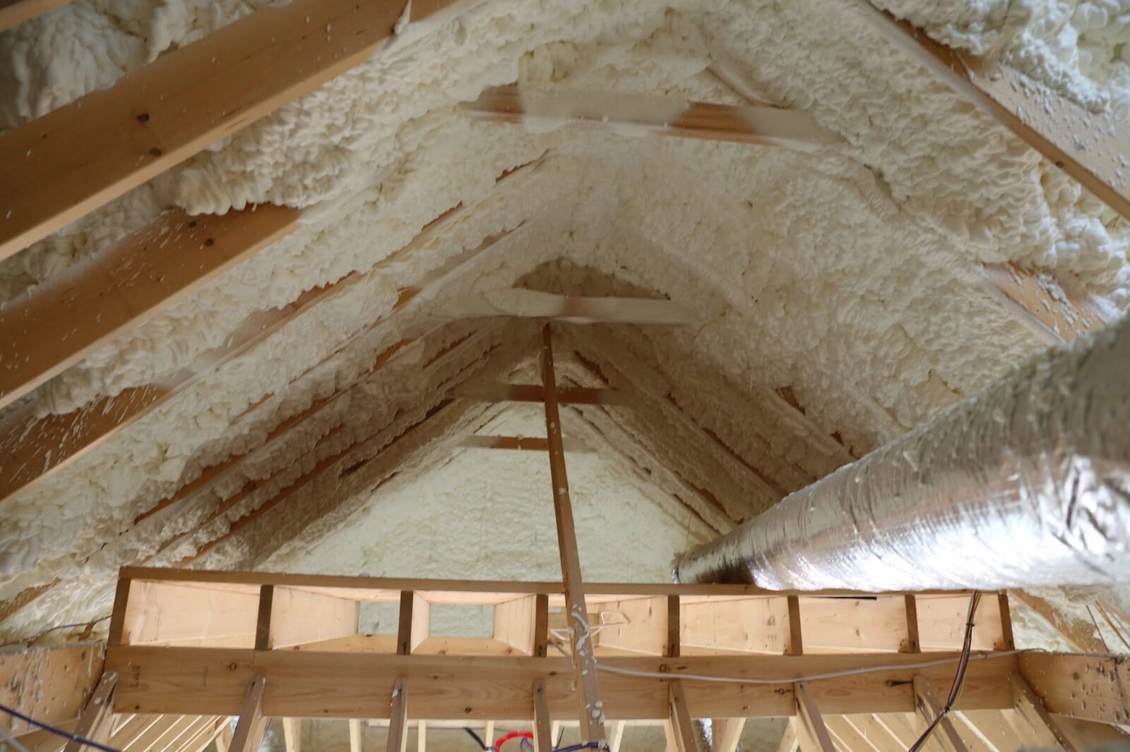 Spray foam insulation applied between studs