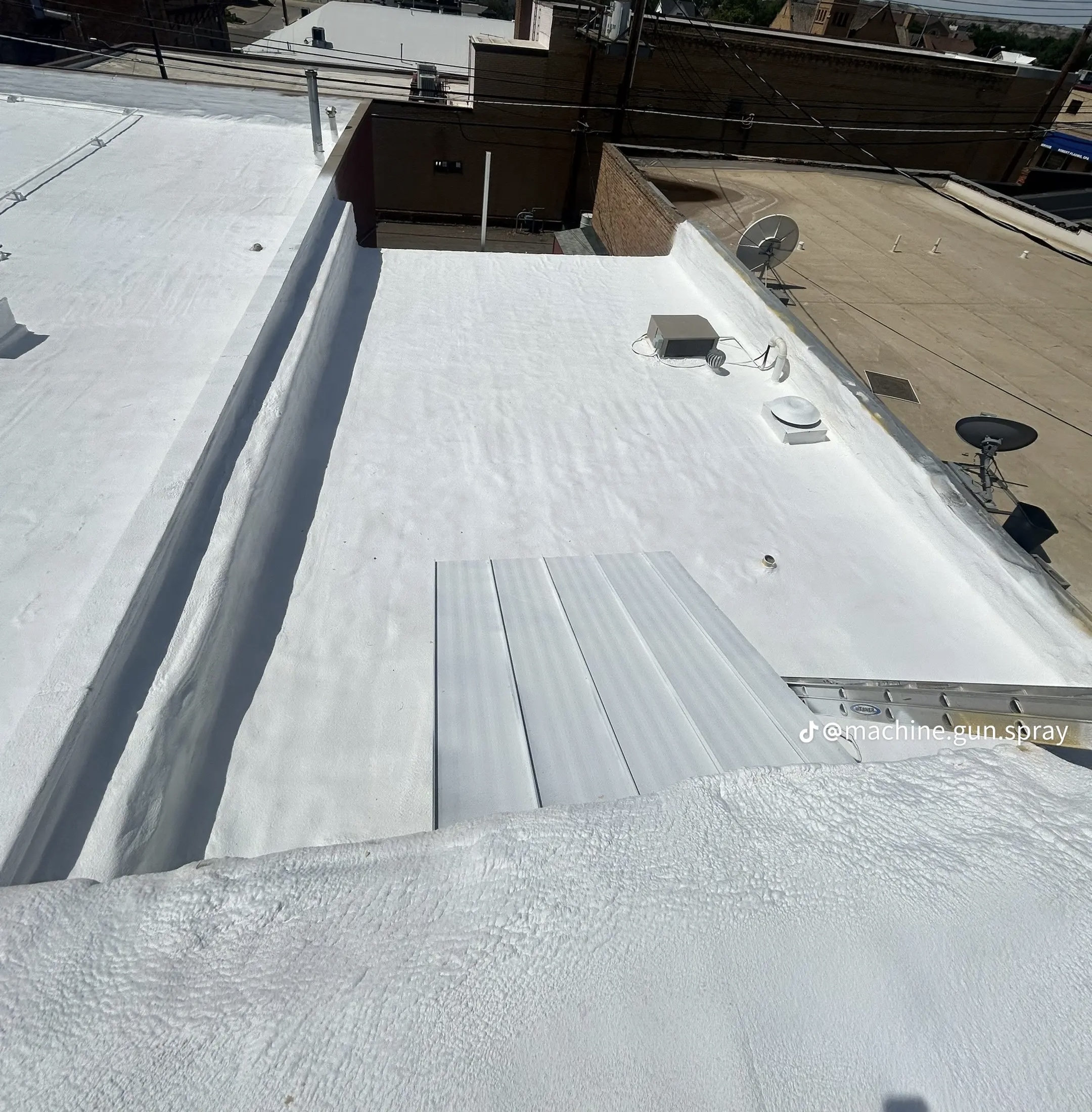 Seamless spray-foam roof with white coating